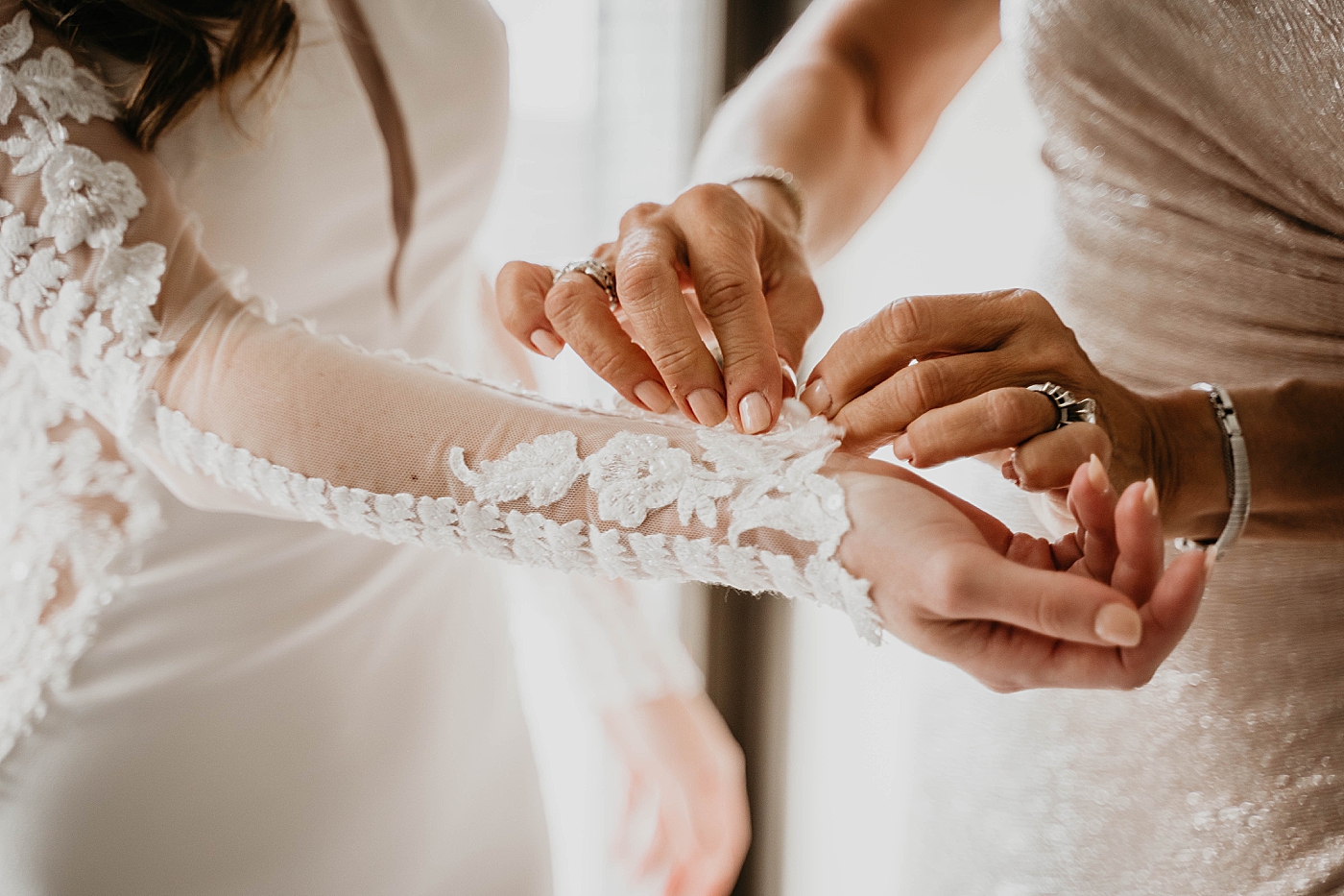 Getting Ready detail shot of finishing the sleeves Waterstone Resort and Marina Wedding captured by South Florida Wedding Photographer Krystal Capone Photography
