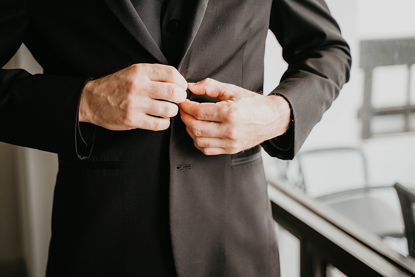 Buttoning the jacket Getting Ready shot Waterstone Resort and Marina Wedding captured by South Florida Wedding Photographer Krystal Capone Photography