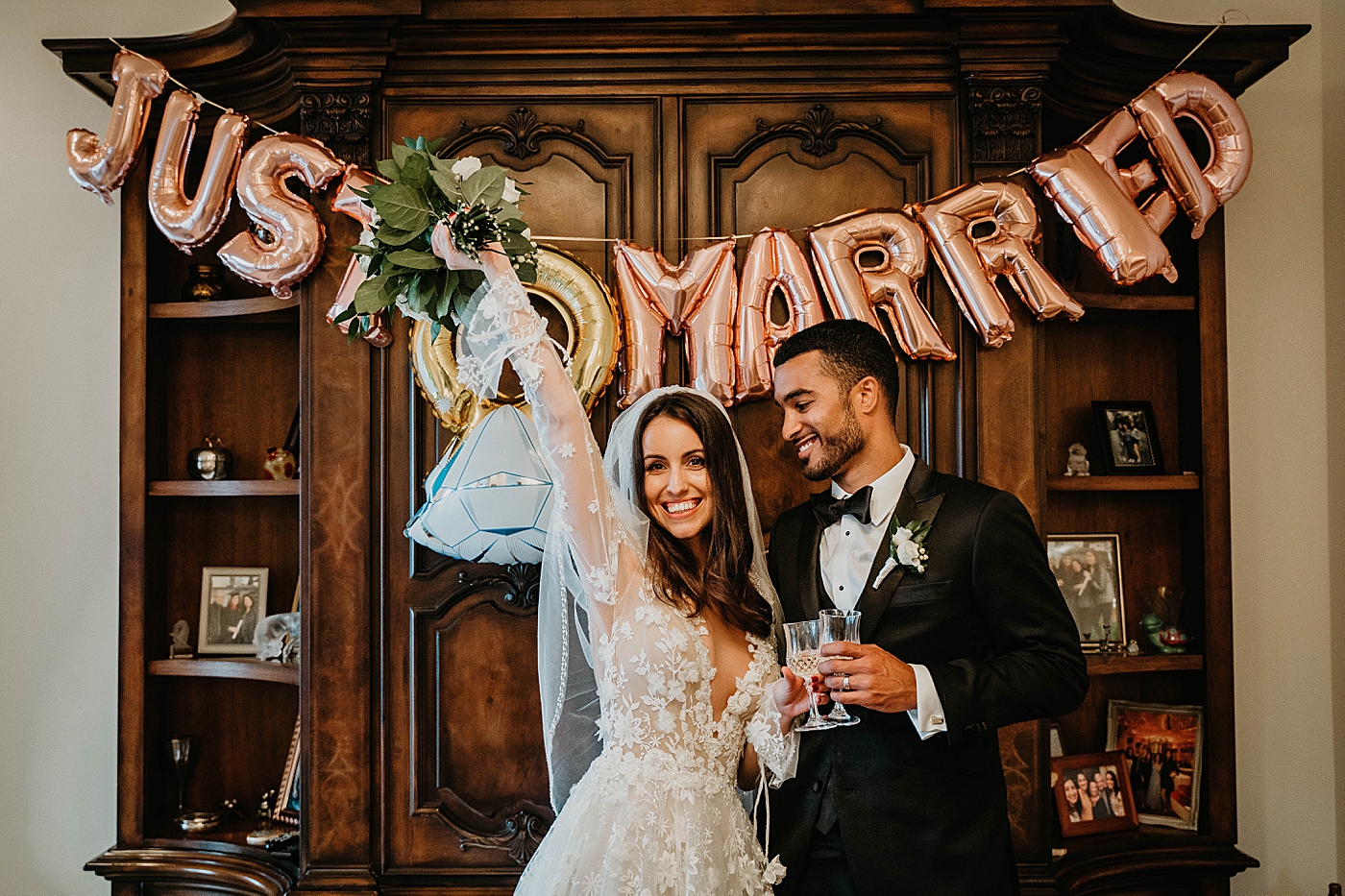 Bride and Groom in front of balloons that say "Just Married" Intimate Home Wedding captured by South Florida Wedding Photographer Krystal Capone Photography