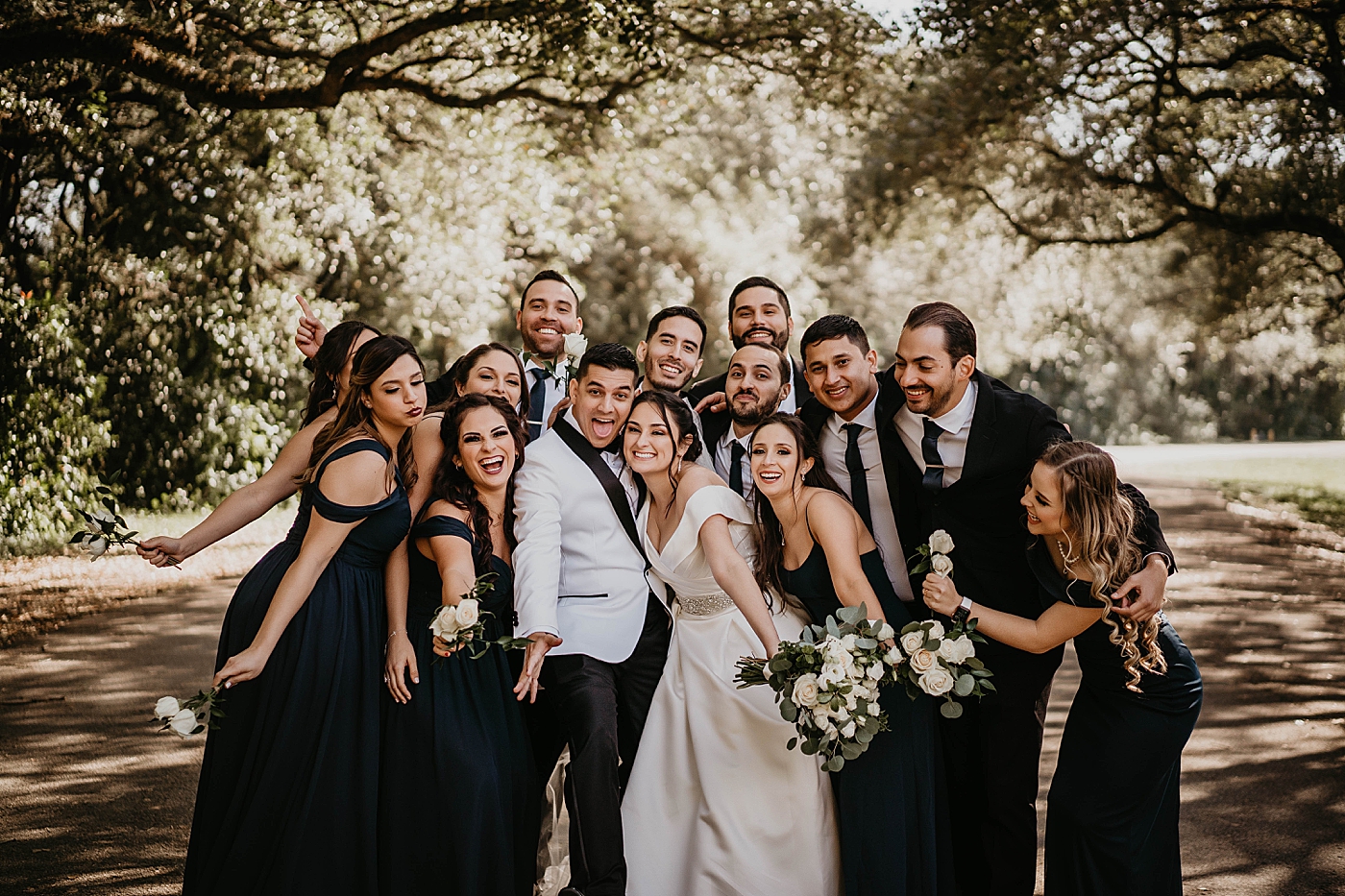 Wedding party gathered in with Bride and Groom for fun portrait Lavan Venue Wedding Photography captured by South Florida Wedding Photographer Krystal Capone Photography
