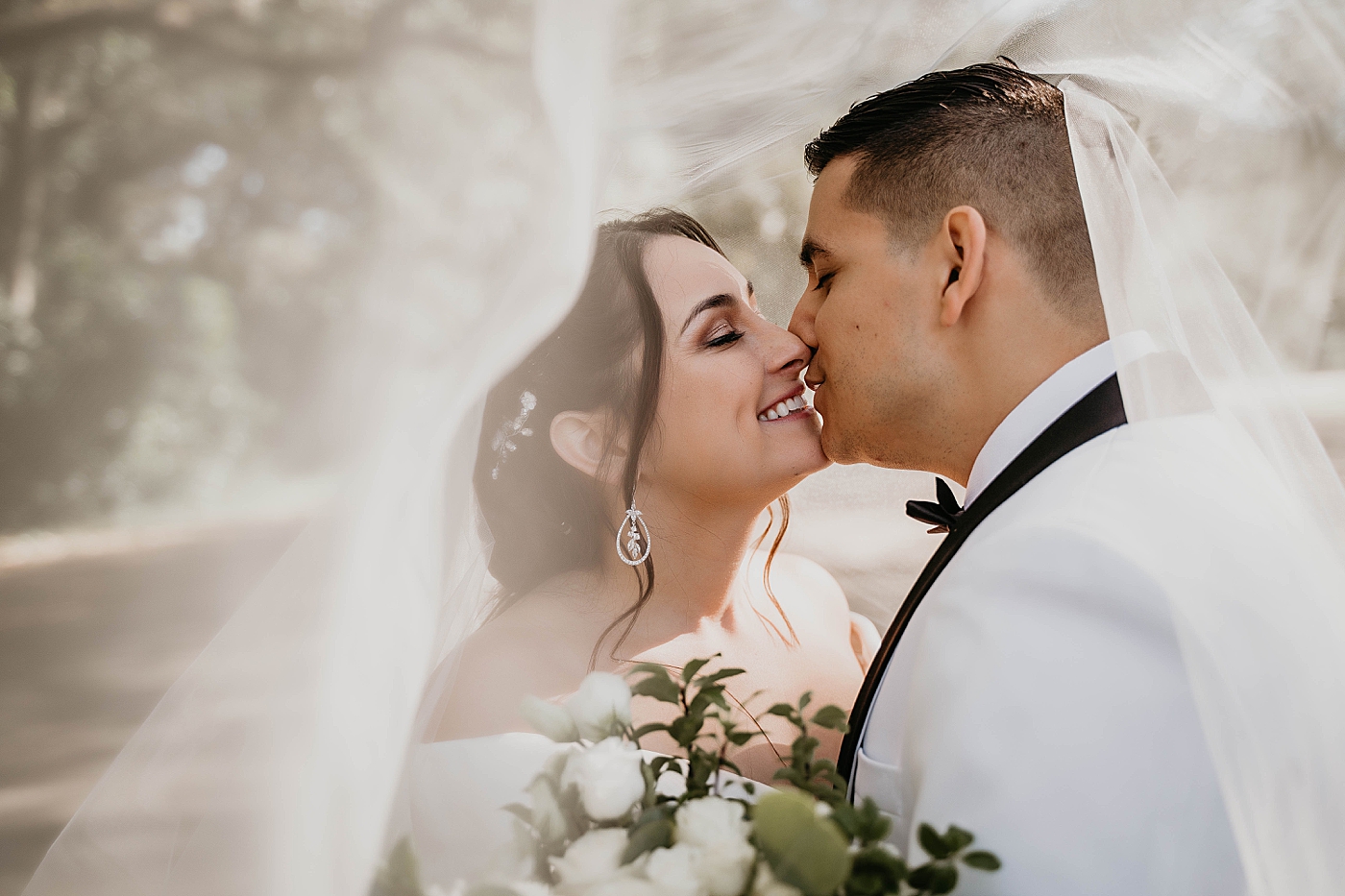 Bride and Groom about to kiss under the veil Lavan Venue Wedding Photography captured by South Florida Wedding Photographer Krystal Capone Photography