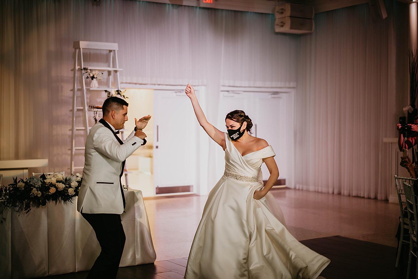Bride and Groom having a fun entrance into Reception Lavan Venue Wedding Photography captured by South Florida Wedding Photographer Krystal Capone Photography