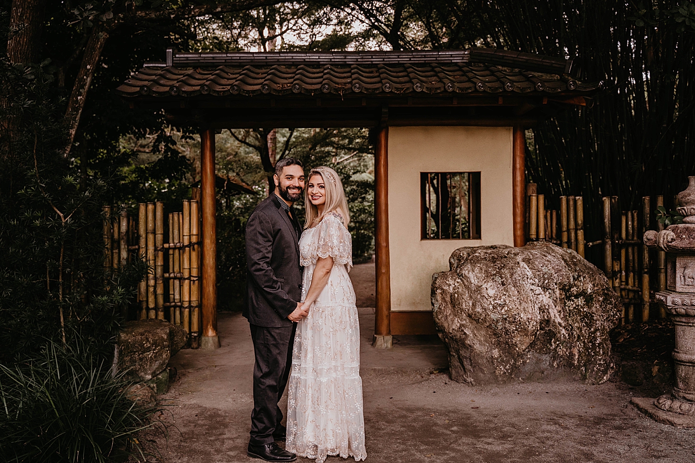 Couple close to each other posing in front of Japanese Garden Scenery Morikami Museum and Japanese Gardens Engagement Photography captured by Krystal Capone Photography