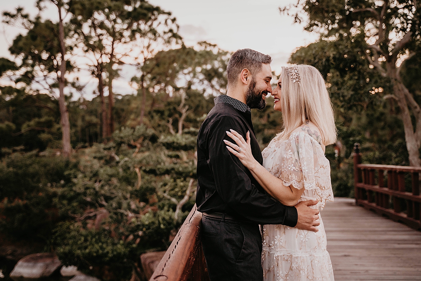 Couple holding each other close Morikami Museum and Japanese Gardens Engagement Photography captured by Krystal Capone Photography