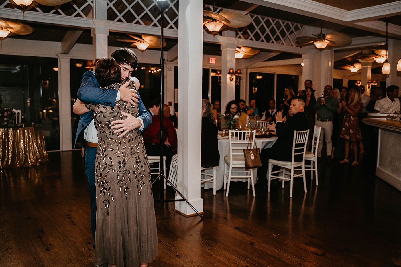 Groom and Mother hugging during dance Out of the Blue Celebrations Wedding Photography captured by South Florida Wedding Photographer Krystal Capone Photography 