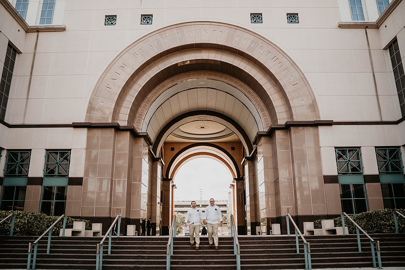 Wide shot of Couple walking down staircase Palm Beach Elopement Photography captured by South Florida Photographer Krystal Capone Photography 