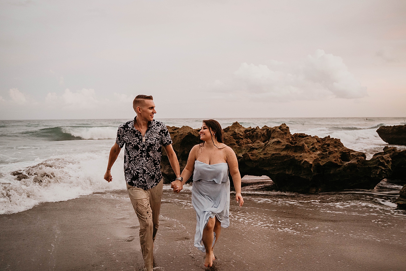 Couple running on the beach South Florida Beach Photography captured by Krystal Capone Photography