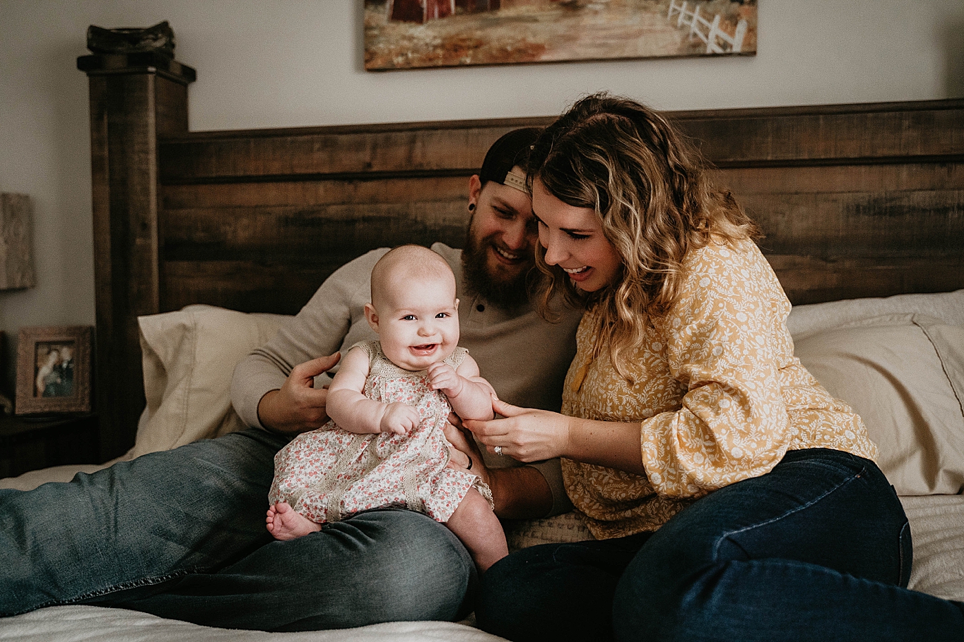 Mom playing with baby on Dad's lap making baby laugh At Home South Florida Family Photography captured by South Florida Family Photographer Krystal Capone Photography 