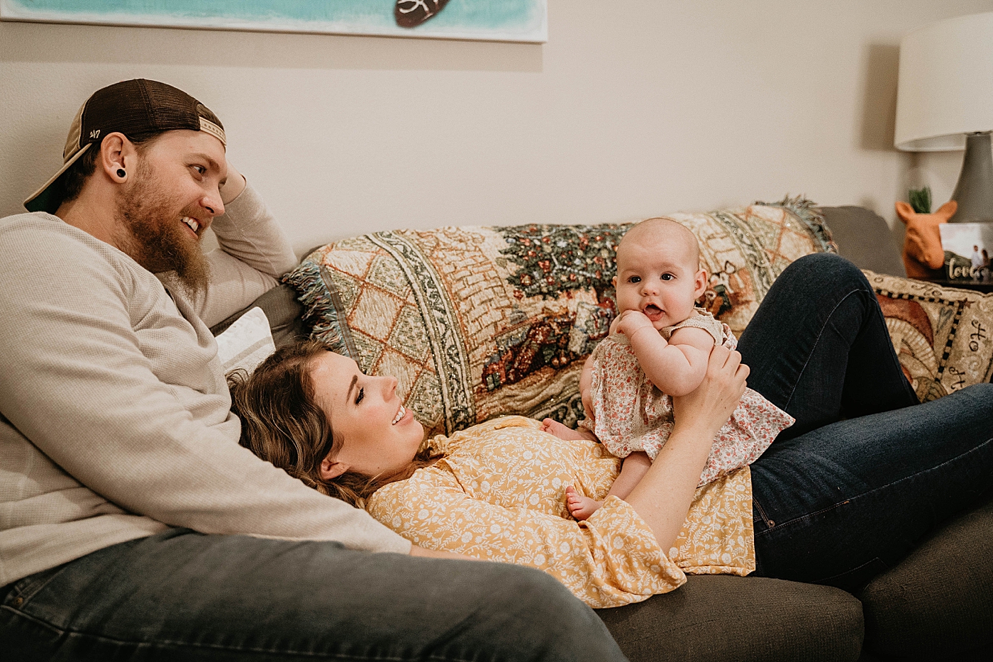 Baby sitting on Mom's stomach sucking thumb At Home South Florida Family Photography captured by South Florida Family Photographer Krystal Capone Photography 