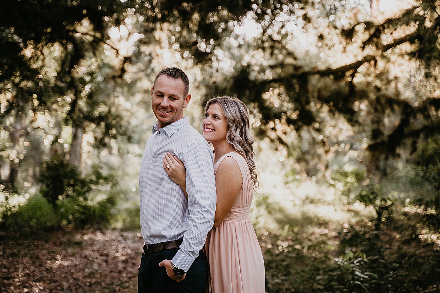 woman holding man from behind Riverbend Park Engagement Photography captured by South Florida Engagement Photographer Krystal Capone Photography