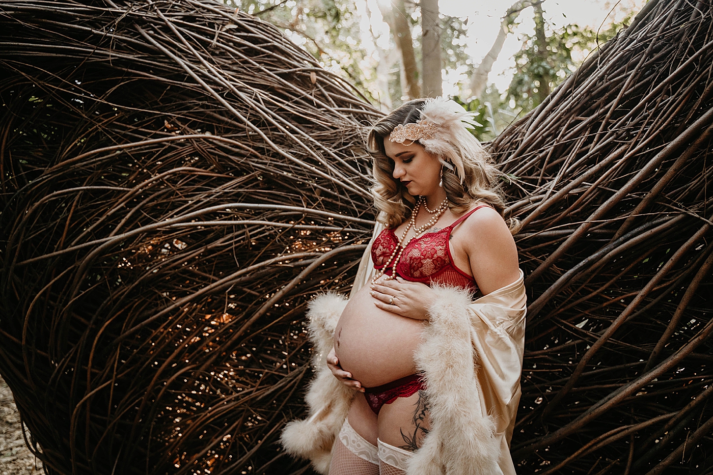 Soon to be mother holding pregnant stomach in front of beautiful branch formation South Florida Maternity Photography captured by South Florida Family Photographer Krystal Capone Photography 