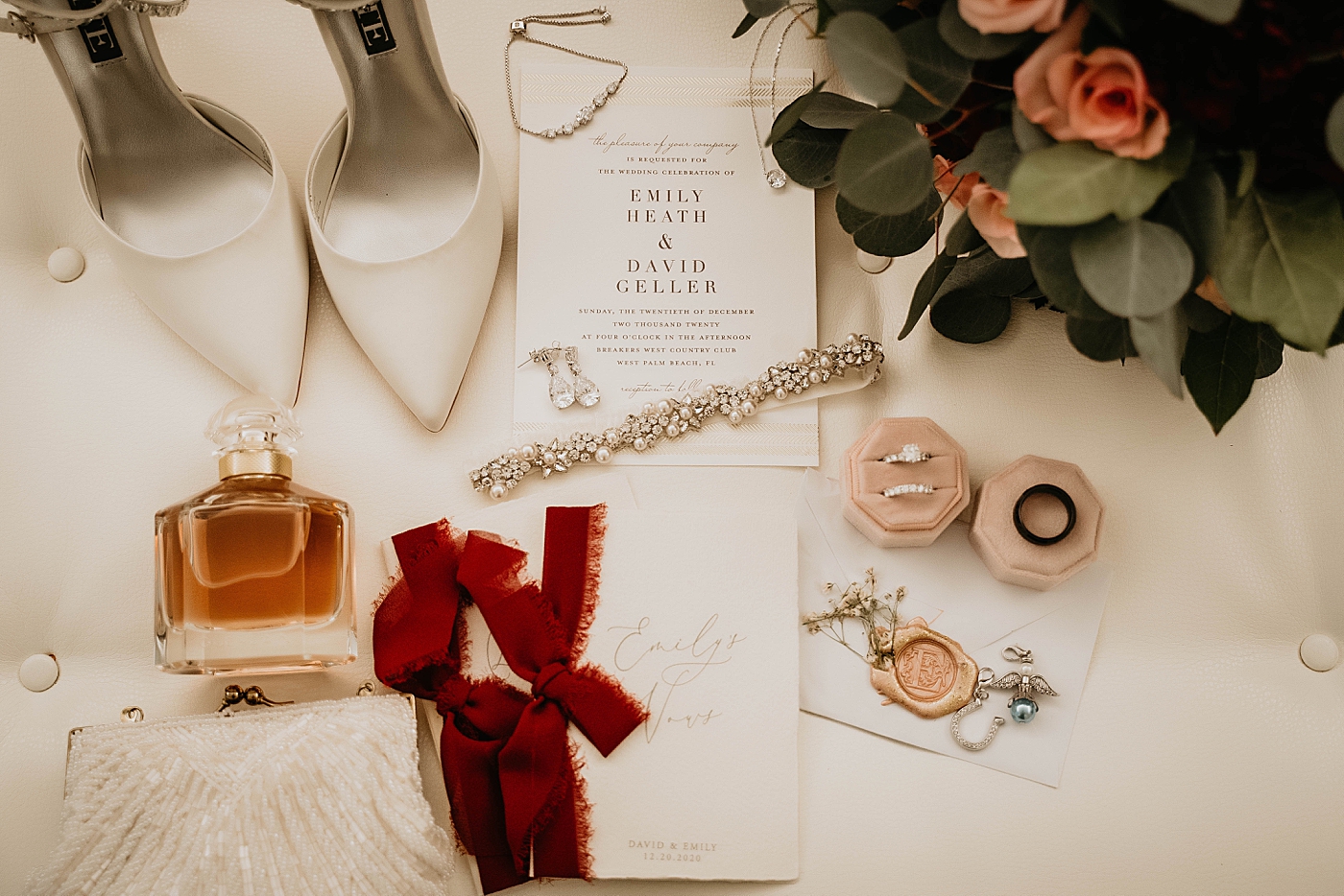 Wedding detail shot of Wedding bands invitations and perfume bottle Breakers West Wedding Photography captured by South Florida Wedding Photographer Krystal Capone Photography 