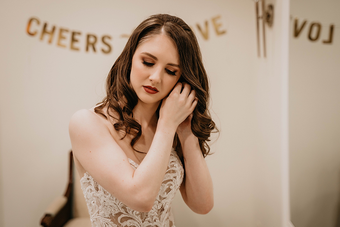 Bride getting ready putting earrings on Breakers West Wedding Photography captured by South Florida Wedding Photographer Krystal Capone Photography 