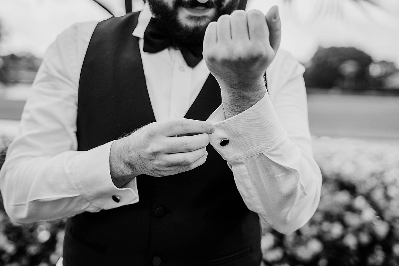B&W Groom adjusting collar Breakers West Wedding Photography captured by South Florida Wedding Photographer Krystal Capone Photography 