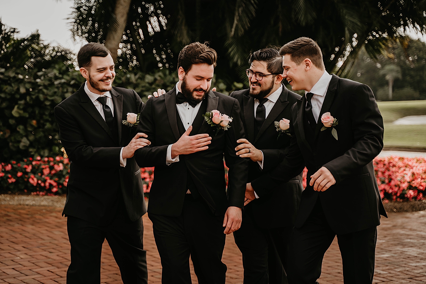 Candid shot of Groomsmen congratulating Groom Breakers West Wedding Photography captured by South Florida Wedding Photographer Krystal Capone Photography 