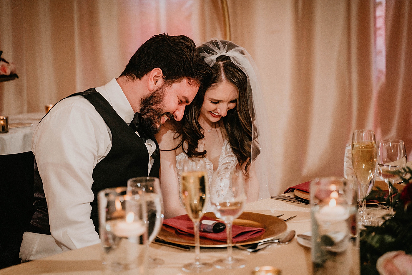 Bride and Groom heads bowed at sweetheart table Breakers West Wedding Photography captured by South Florida Wedding Photographer Krystal Capone Photography 