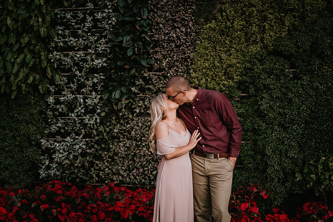 Couple kissing in front of hedge Worth Ave Engagement Photography captured by Engagement Photographer Krystal Capone Photography