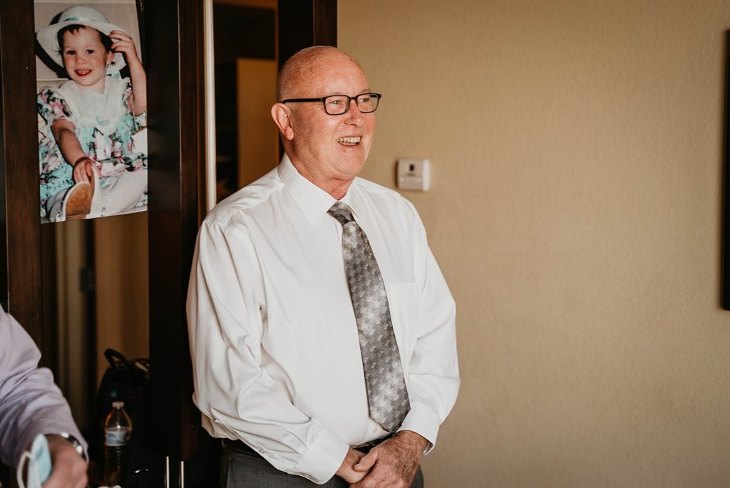 Father smiling getting ready by old Polaroid picture 94th Aero Squadron Miami Wedding Photography captured by South Florida Engagement Photographer Krystal Capone Photography  