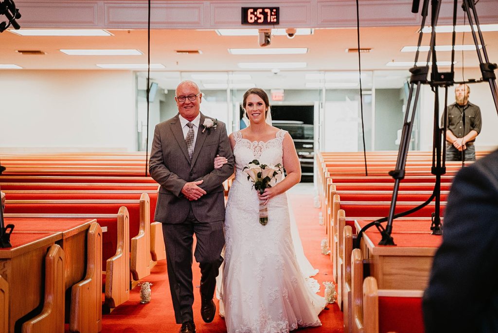 Bride and father entering arm in arm Ceremony 94th Aero Squadron Miami Wedding Photography captured by South Florida Engagement Photographer Krystal Capone Photography 