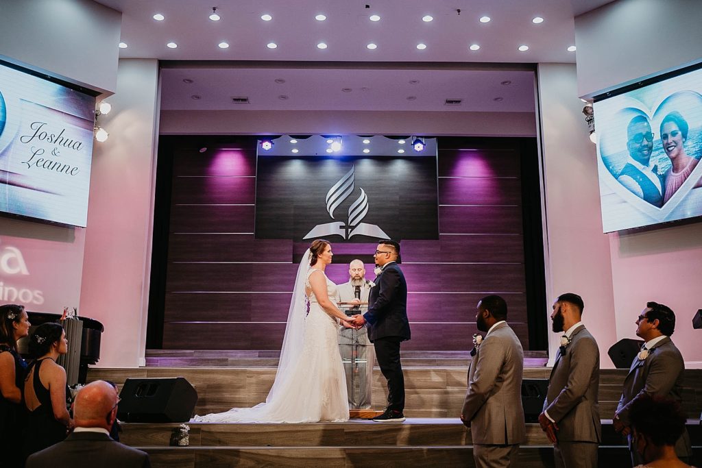 Bride and Groom hand in hand during Homily 94th Aero Squadron Miami Wedding Photography captured by South Florida Engagement Photographer Krystal Capone Photography 