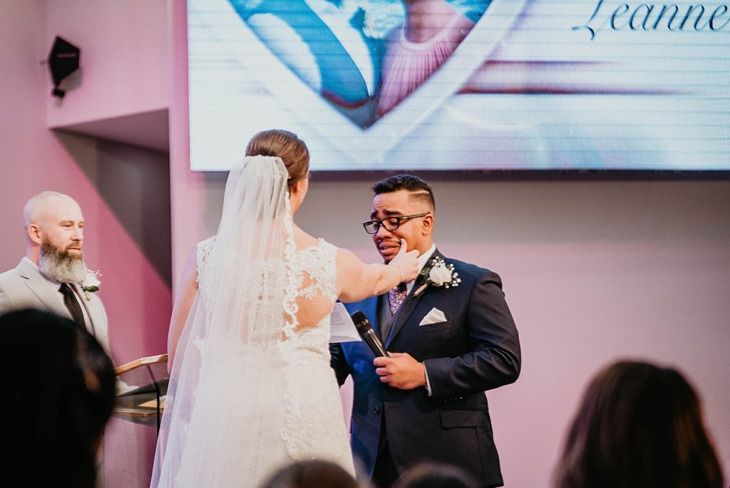 Groom crying during Ceremony with Bride wiping away tears 94th Aero Squadron Miami Wedding Photography captured by South Florida Engagement Photographer Krystal Capone Photography 
