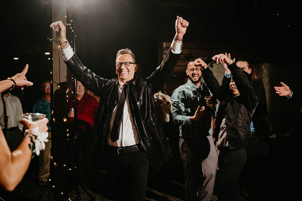 Single Bachelor celebrating after catching the garter Ever After Farms Wedding Photography captured by South Florida Wedding Photographer Krystal Capone Photography 