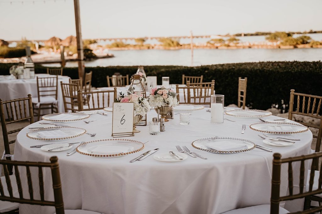 Reception detail shot with table numbers and light flower centerpieces Hawks Cay Resort Wedding Photography captured by South Florida Wedding Photographer Krystal Capone Photography 