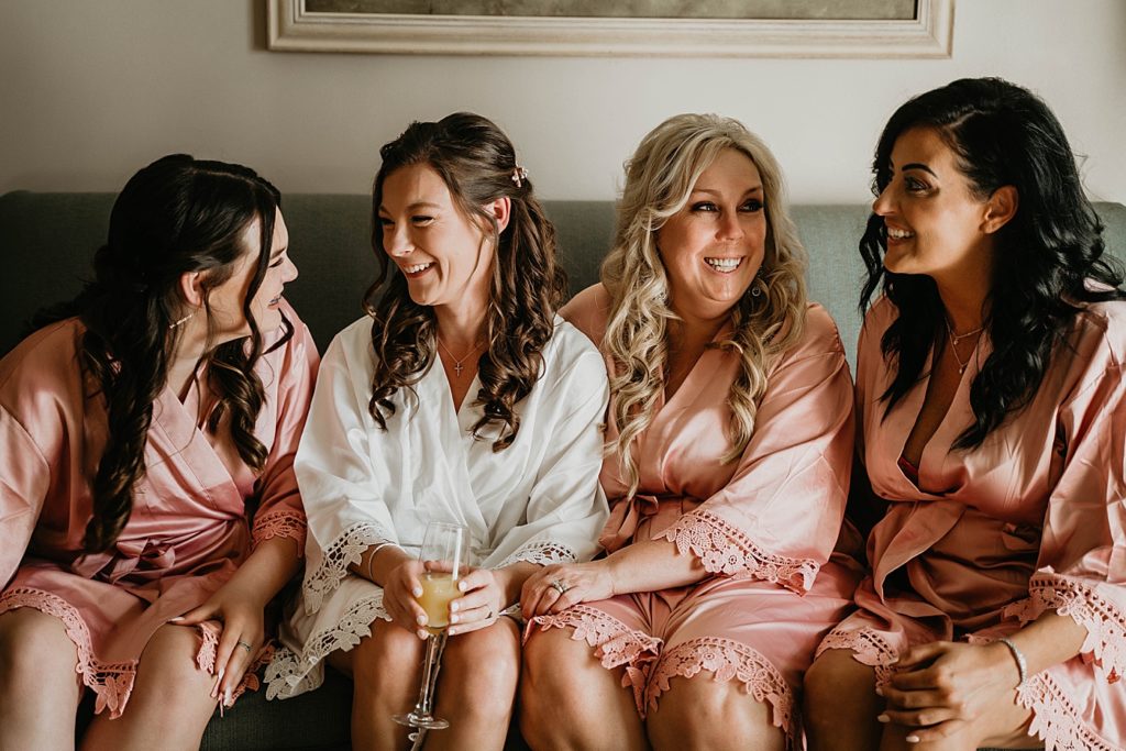 Bride with mimosa with Bridesmaids before getting ready in robes Hawks Cay Resort Wedding Photography captured by South Florida Wedding Photographer Krystal Capone Photography  