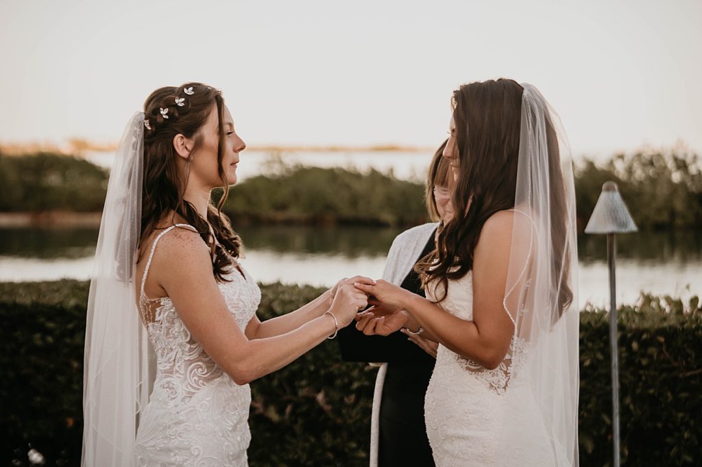 Brides hand in hand during Ceremony Hawks Cay Resort Wedding Photography captured by South Florida Wedding Photographer Krystal Capone Photography