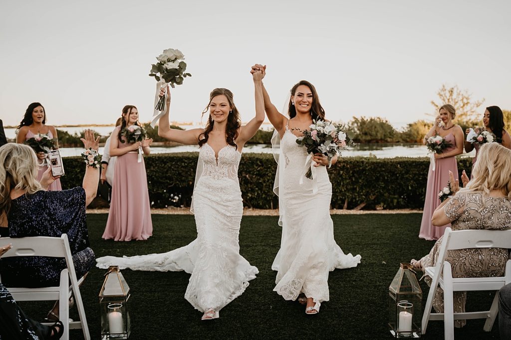 Brides hand in hand Just married exiting Ceremony with applause Hawks Cay Resort Wedding Photography captured by South Florida Wedding Photographer Krystal Capone Photography