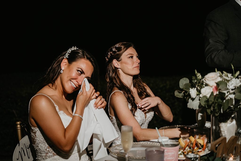 Brides emotional during toast at sweetheart table with shrimp cocktail Hawks Cay Resort Wedding Photography captured by South Florida Wedding Photographer Krystal Capone Photography