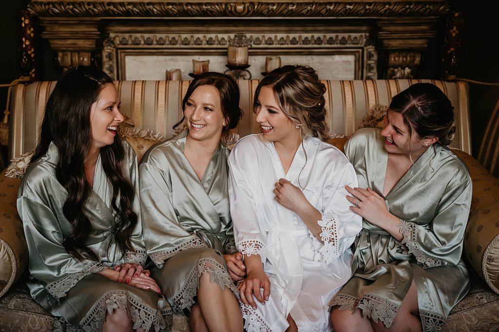 Bride with Bridesmaids before Getting Ready in silk robes Intimate South Florida Wedding Photography captured by South Florida Wedding Photographer Krystal Capone Photography