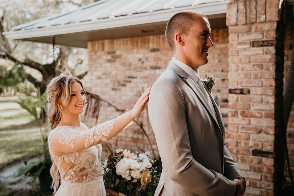 First Look Bride tapping Groom on shoulder and holding bouquet Intimate South Florida Wedding Photography captured by South Florida Wedding Photographer Krystal Capone Photography