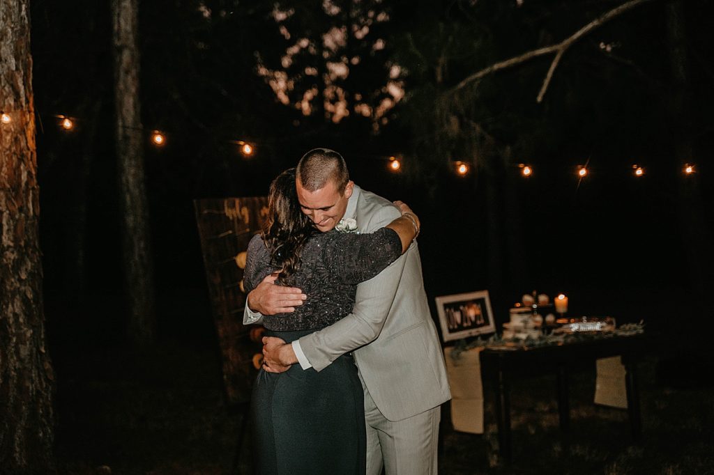 mother son dance at night in the forest Intimate South Florida Wedding Photography captured by South Florida Wedding Photographer Krystal Capone Photography