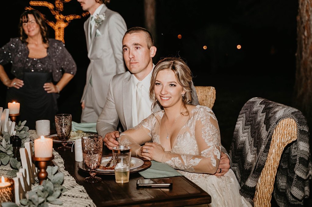 Bride and Groom listening to speech sitting at sweetheart table Intimate South Florida Wedding Photography captured by South Florida Wedding Photographer Krystal Capone Photography