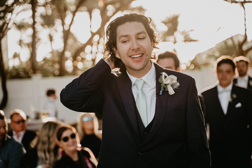 Groom entering ceremony Jupiter Beach Resort Wedding Photography captured by South Florida Wedding Photographer Krystal Capone Photography 