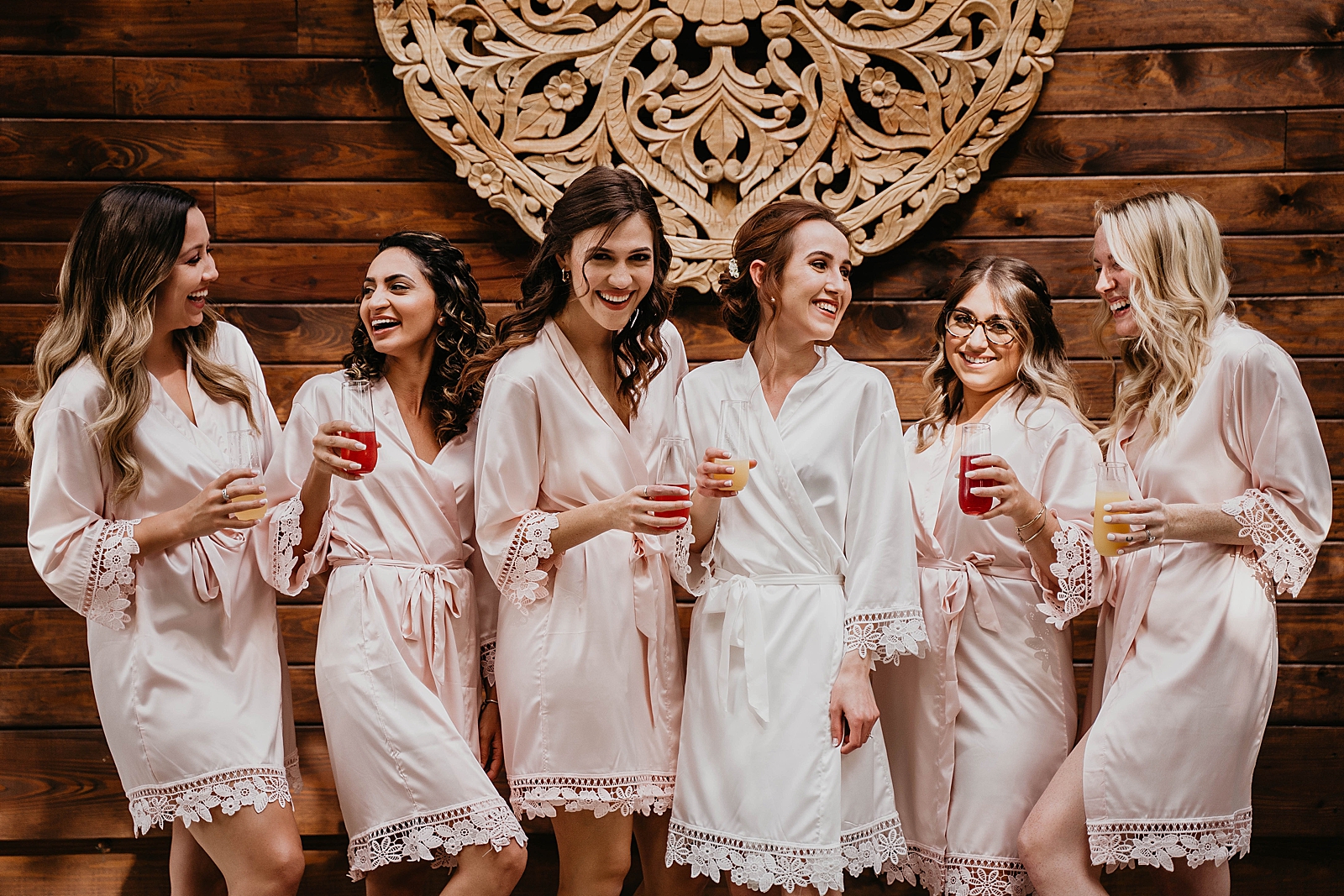 Bride with Bridesmaids Getting Ready with Drinks and silk robes Living Sculptures Sanctuary Wedding Photography captured by South Florida Wedding Photographer Krystal Capone Photography