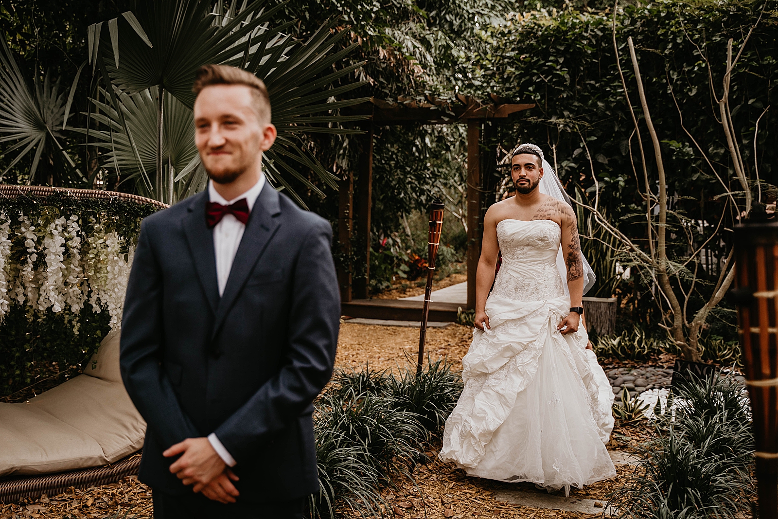 Groom with back turned and decoy Bride approaching its just a prank bro Living Sculptures Sanctuary Wedding Photography captured by South Florida Wedding Photographer Krystal Capone Photography