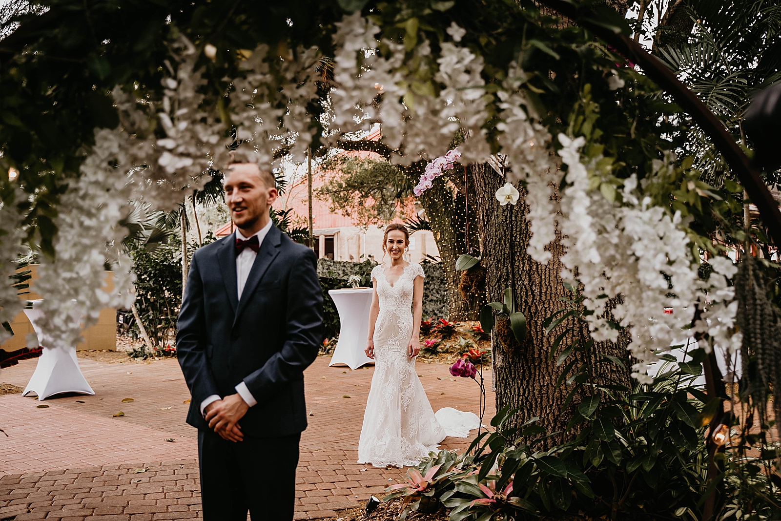 Groom with back turned with Bride coming from behind outdoor First Look Living Sculptures Sanctuary Wedding Photography captured by South Florida Wedding Photographer Krystal Capone Photography