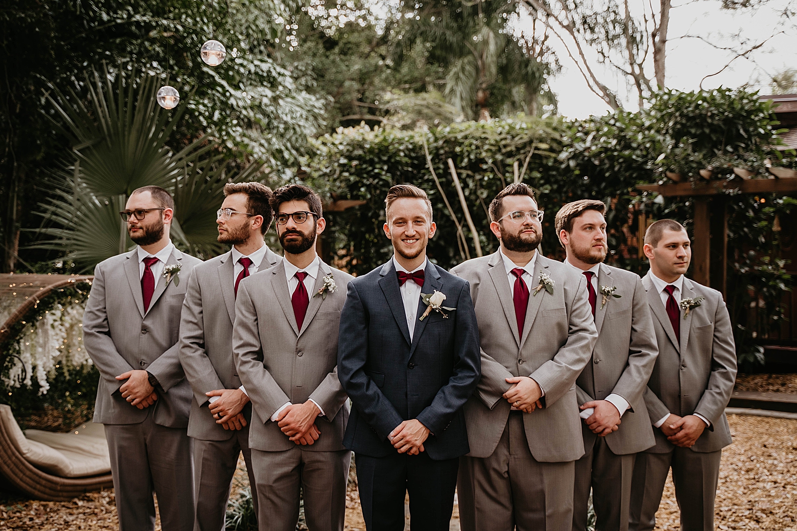 Groom standing in formation with Groomsmen in greenery Living Sculptures Sanctuary Wedding Photography captured by South Florida Wedding Photographer Krystal Capone Photography
