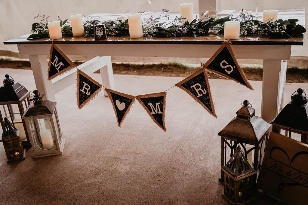 Detail shot of sweetheart table with Mr and Mrs fabric streamer The Lake House Fort Pierce Wedding Photography captured by South Florida Wedding Photographer Krystal Capone Photography 