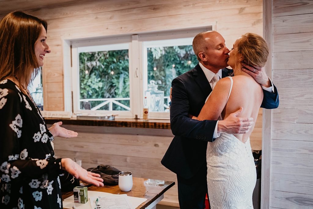 Bride and Groom kissing as they enter Reception The Lake House Fort Pierce Wedding Photography captured by South Florida Wedding Photographer Krystal Capone Photography 