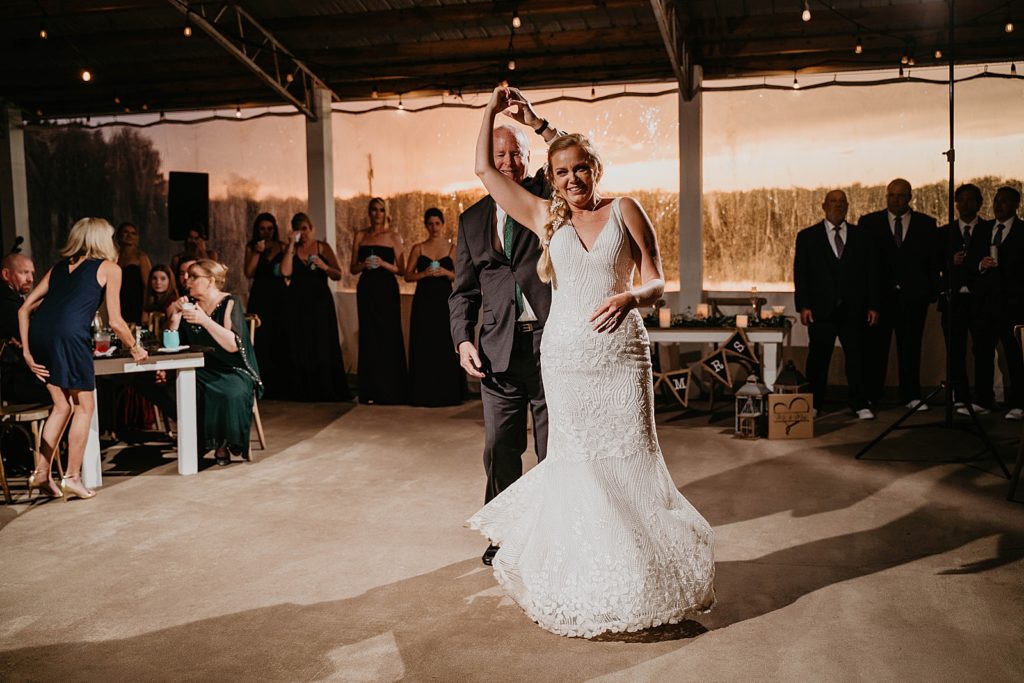 Bride and Groom pirouetting Reception The Lake House Fort Pierce Wedding Photography captured by South Florida Wedding Photographer Krystal Capone Photography 