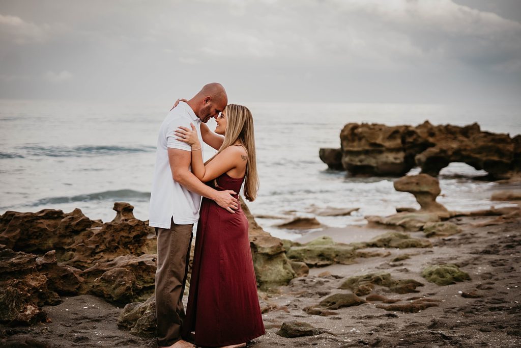 Couple resting their heads on each other on the beach