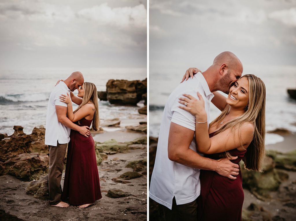 Couple nuzzling on drift rocks on the beach