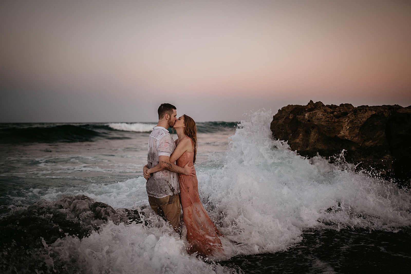 Couple hugging and kissing on the beach