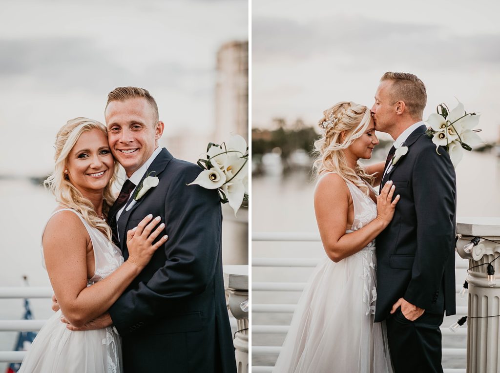 Bride and Groom holding each other close and Groom kissing Bride on the forehead