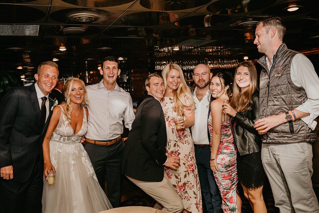 Bride and Groom posing with guests