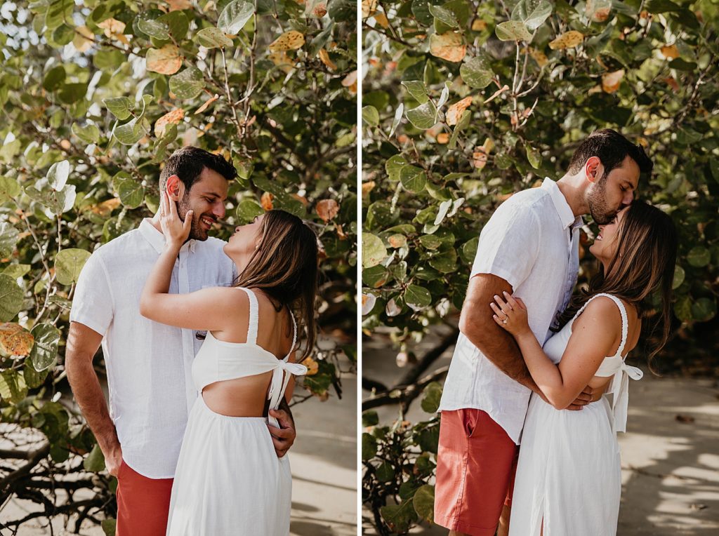 Couple holding each other and man kissing woman on the forehead