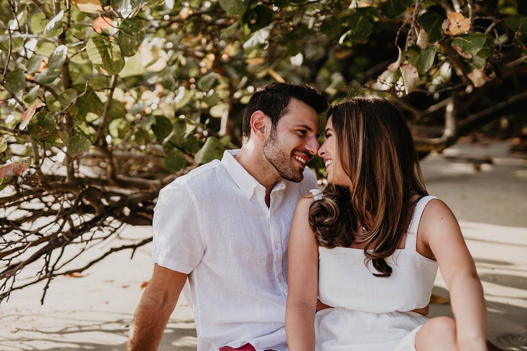 Couple sitting and nuzzling their noses against each other